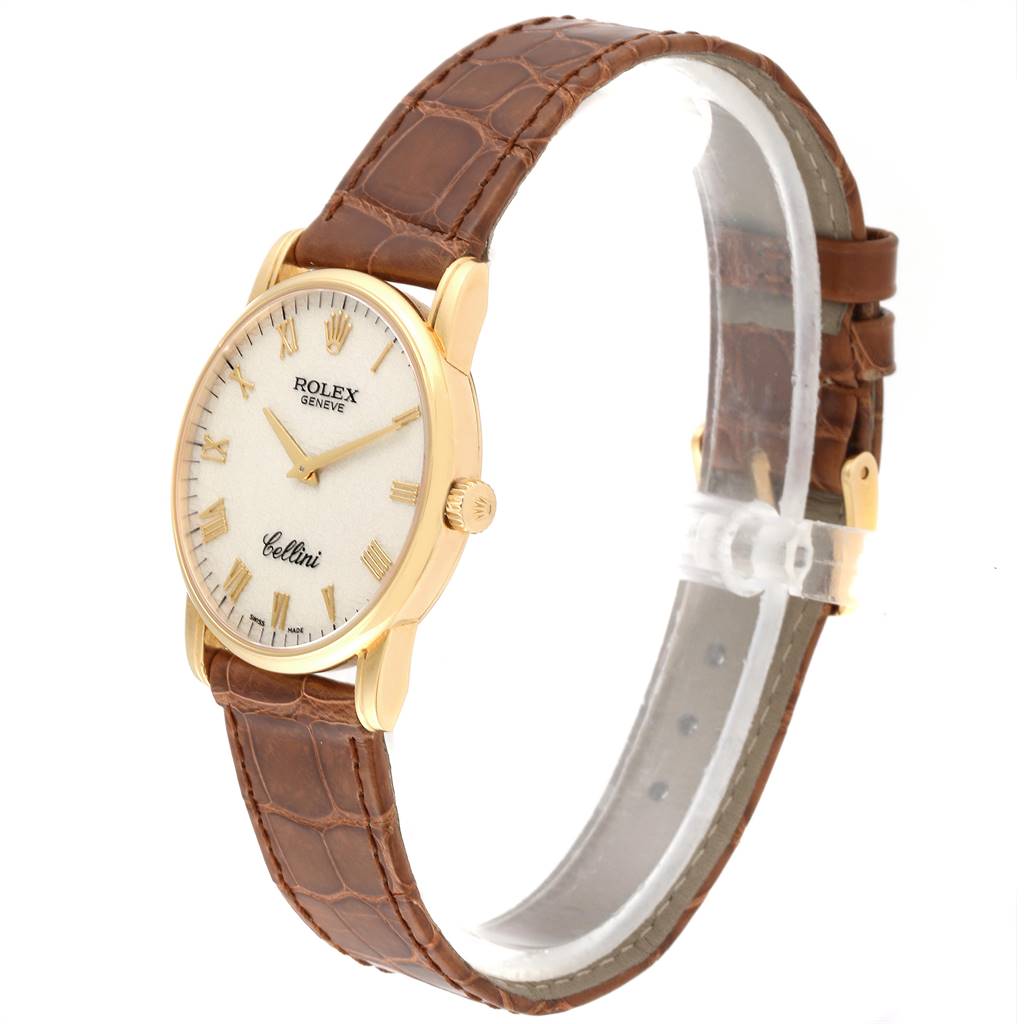 The Rolex Cellini 5116 Men's Yellow Gold Beige Dial 5116 Men's Yellow Gold Beige Dial watch is shown at a slight angle, displaying its face, crown, and brown leather strap.