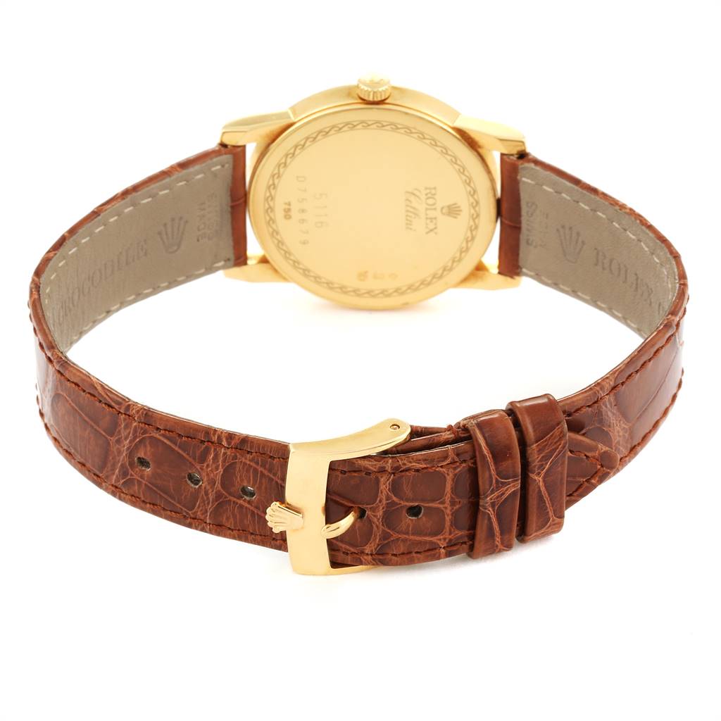 The image shows the back view of the Rolex Cellini 5116 Men's Yellow Gold Beige Dial 5116 Men's Yellow Gold Beige Dial watch, highlighting its gold case and brown leather strap with a gold buckle.