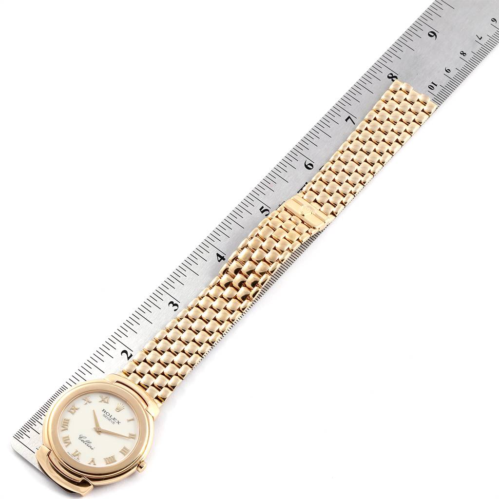 The Rolex Cellini 6623 Men's Yellow Gold Beige Dial 6623 Men's Yellow Gold Beige Dial watch is shown from above, displaying its face, gold bracelet, and part of a ruler for scale.