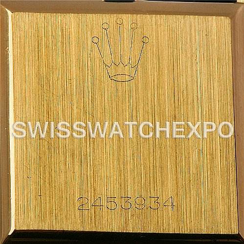 This image shows the back casing of a Rolex Cellini 4014 Men's Yellow Gold Brown Dial 4014 Men's Yellow Gold Brown Dial watch, featuring a gold finish with an engraved crown logo and serial number.