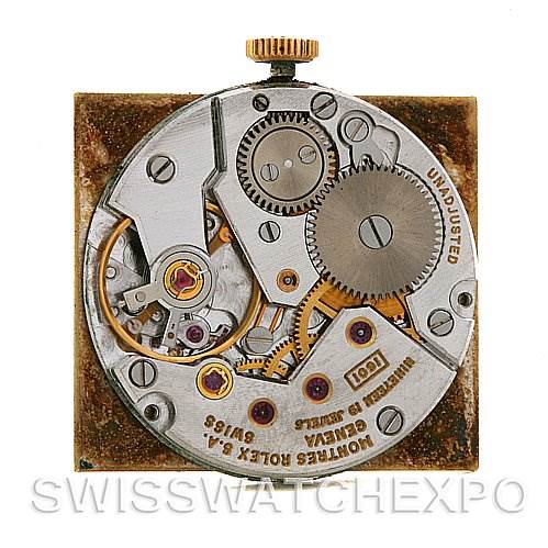 This image displays the intricate movement mechanism of a Rolex Cellini 4014 Men
s Yellow Gold Champagne Dial 4014 Men
s Yellow Gold Champagne Dial watch, featuring gears, springs, and a winding crown.