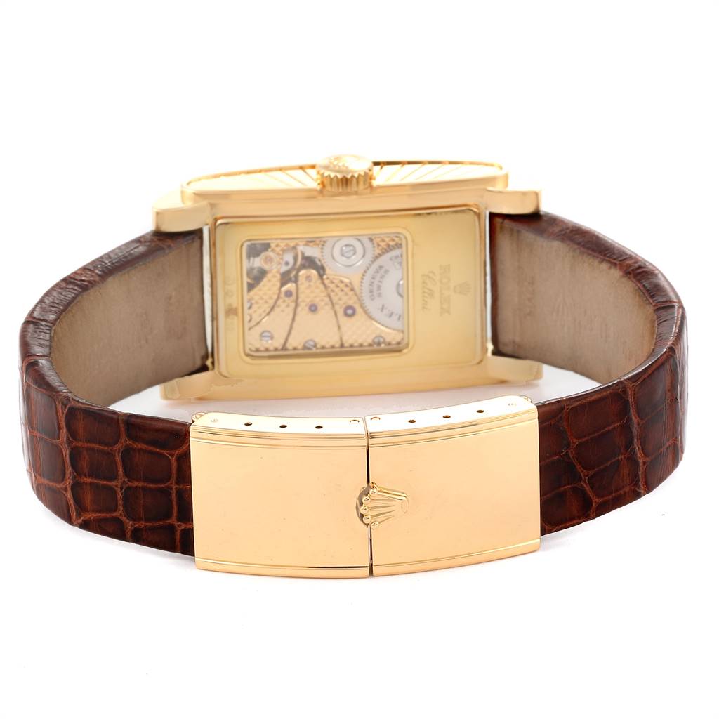 The image shows the back view of a Rolex Cellini 5440/8 Men's Yellow Gold Champagne Dial 5440/8 Men's Yellow Gold Champagne Dial watch, highlighting its mechanical movement and brown leather strap with a gold clasp.