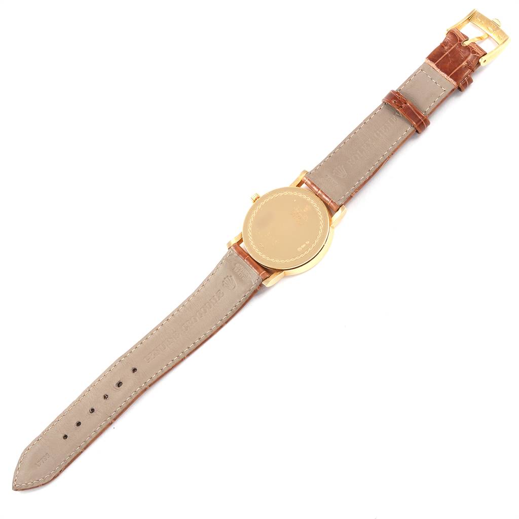 The image shows the backside and leather strap of a Rolex Cellini 5115 Yellow Gold Mother of Pearl Dial 5115 Yellow Gold Mother of Pearl Dial watch placed flat.