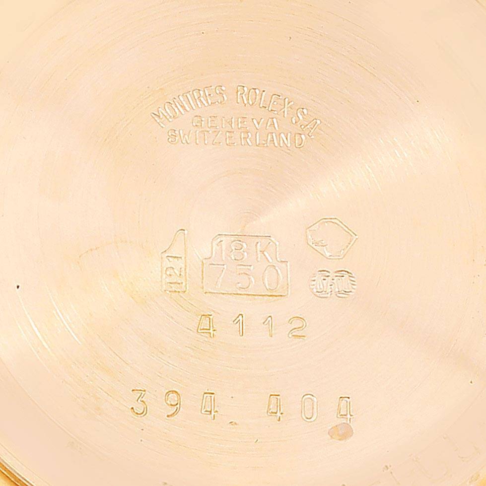 This image shows the inner case back of a Rolex Cellini 4112 Men's Yellow Gold Champagne Dial 4112 Men's Yellow Gold Champagne Dial model, displaying hallmarks and engraved serial numbers.