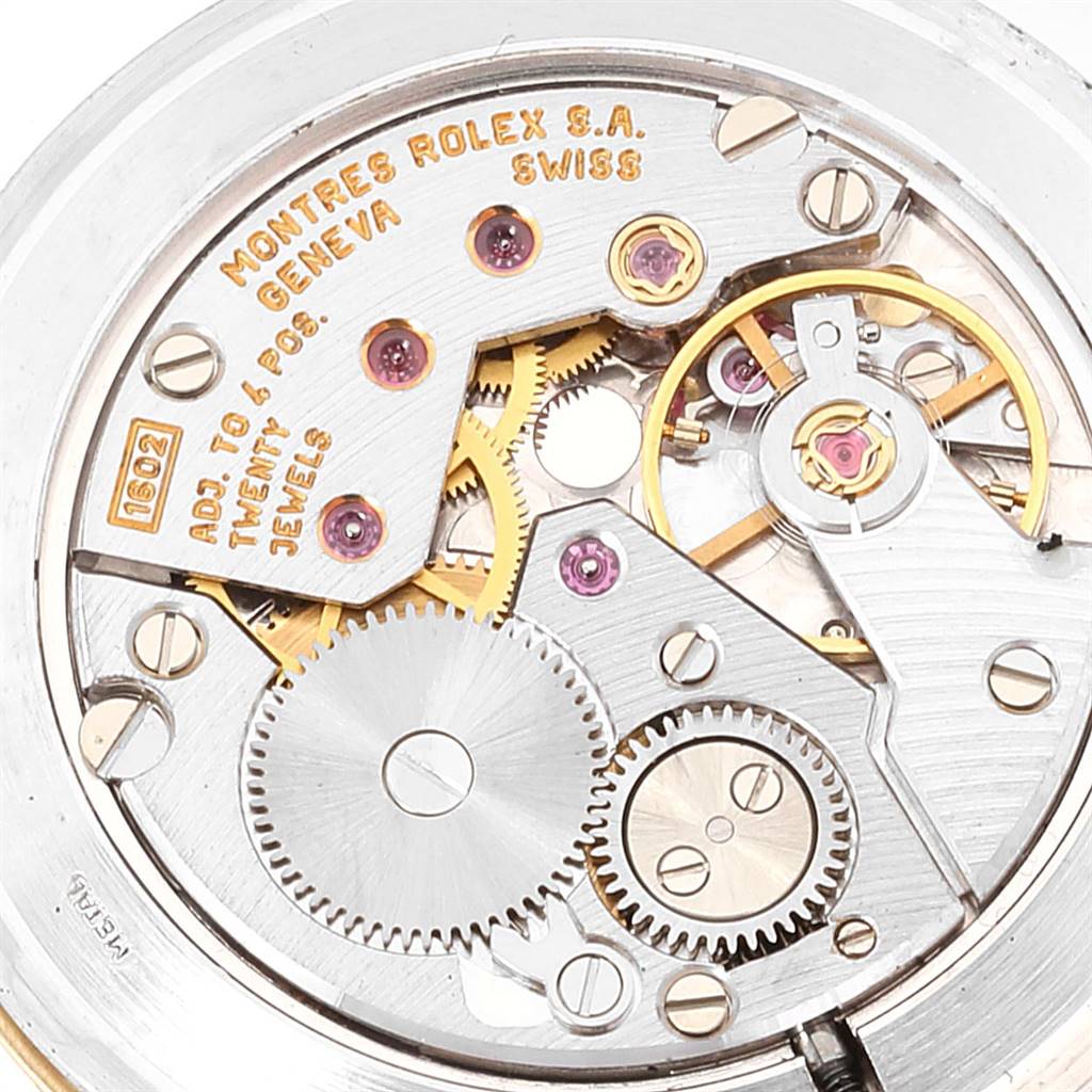This image shows the intricate movement mechanism of a Rolex Cellini 4112 Men's Yellow Gold Champagne Dial 4112 Men's Yellow Gold Champagne Dial watch from a close-up angle, highlighting its gears and jewels.