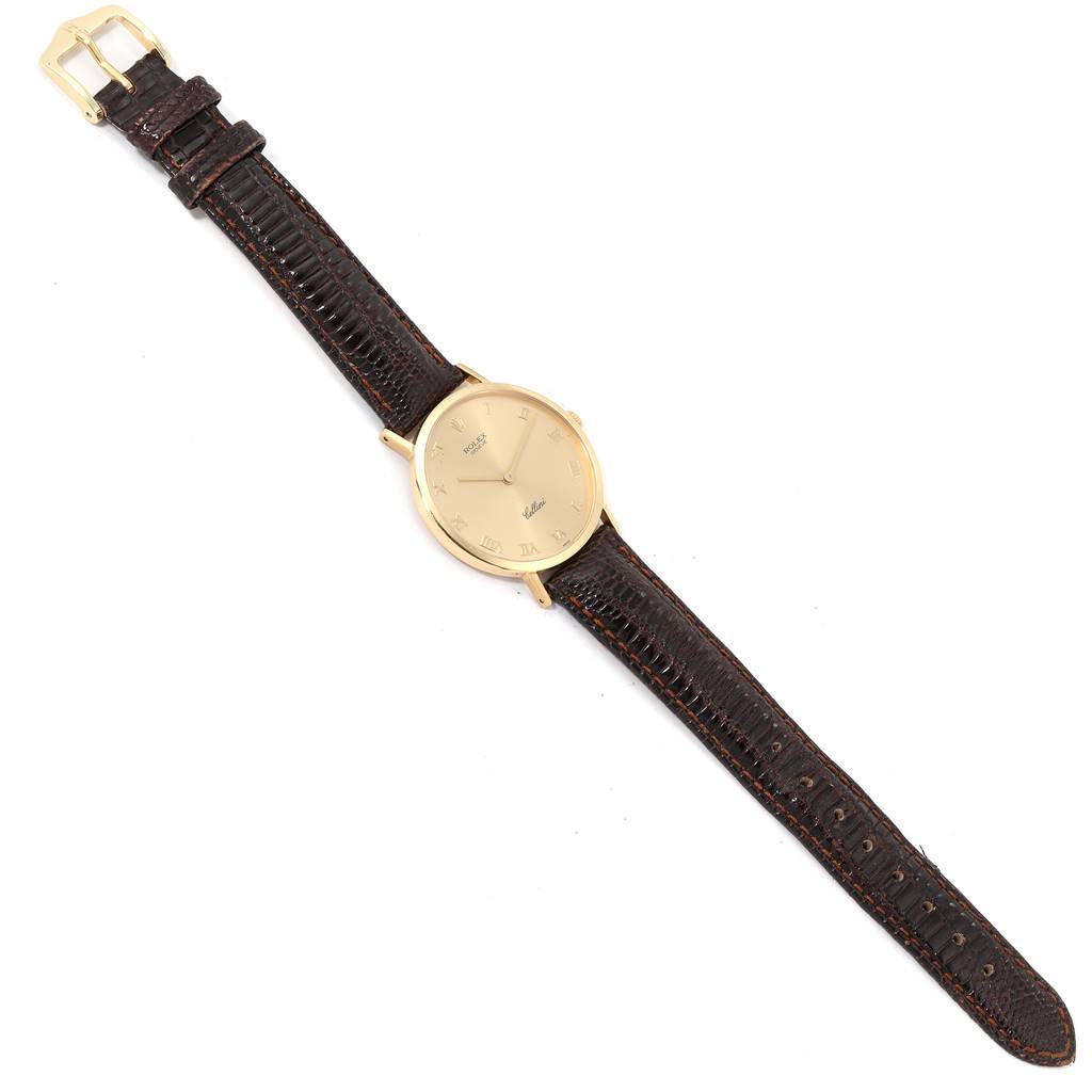 This Rolex Cellini 4112 Men's Yellow Gold Champagne Dial 4112 Men's Yellow Gold Champagne Dial watch is shown from a top-down angle, displaying the full watch face and entire leather strap.