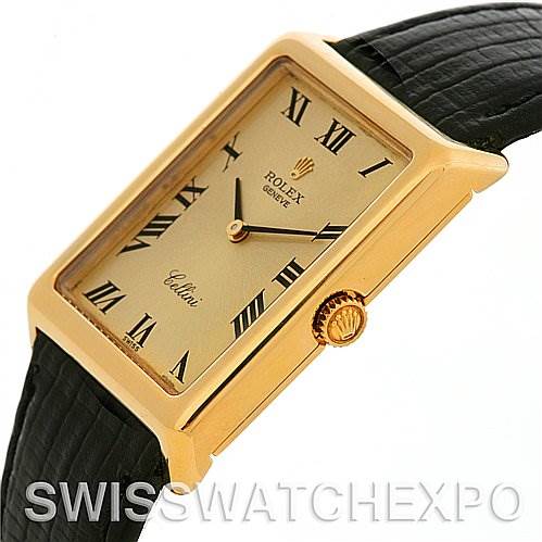 The image shows a Rolex Cellini 4105 Men's Yellow Gold Champagne Dial 4105 Men's Yellow Gold Champagne Dial watch in gold with a rectangular face, Roman numerals, and a black leather strap from an angled side view.