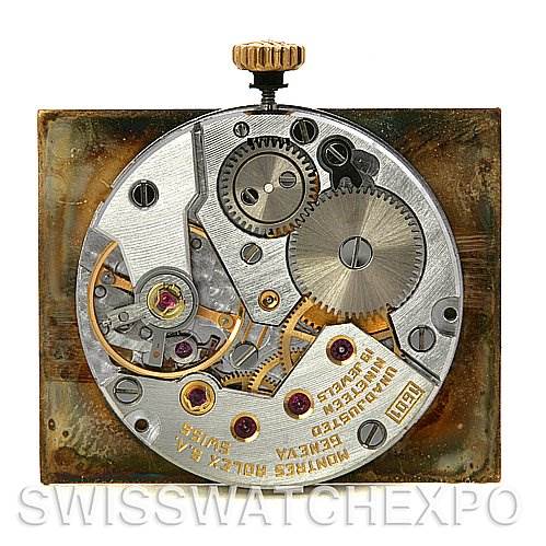 This image shows the internal mechanism of a Rolex Cellini 4105 Men's Yellow Gold Champagne Dial 4105 Men's Yellow Gold Champagne Dial watch, including gears, screws, and the winding crown.