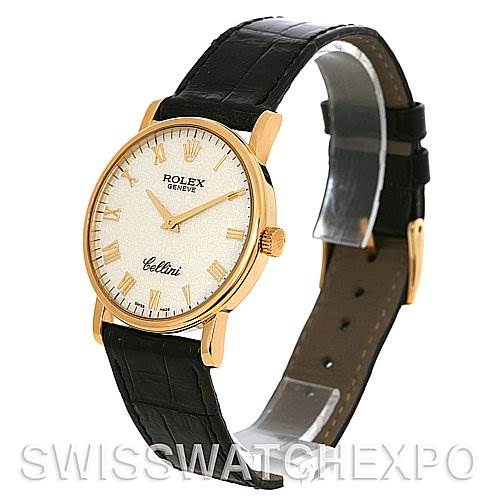 This image shows a side angle of a Rolex Cellini 5115 Men's Yellow Gold Beige Dial 5115 Men's Yellow Gold Beige Dial watch, featuring its gold casing, white dial, and black leather strap.