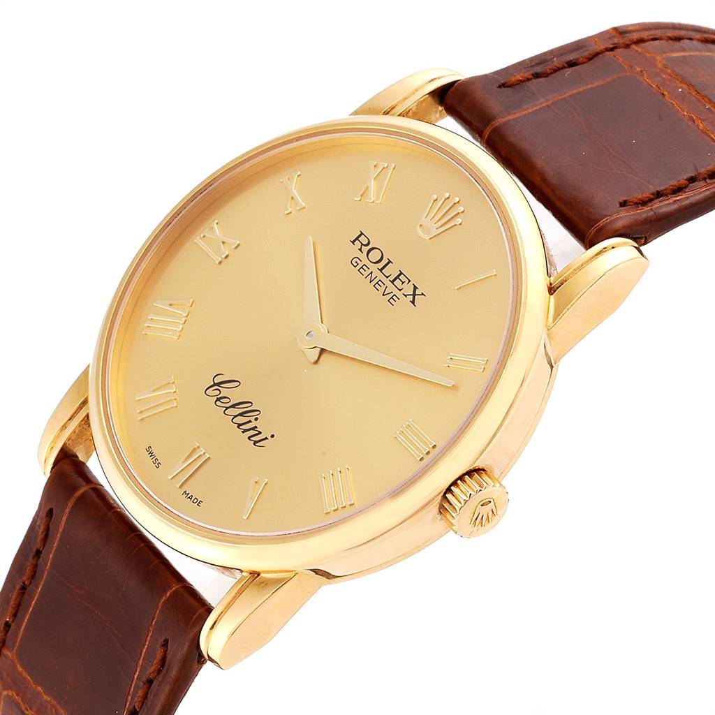 The Rolex Cellini 5116 Men's Yellow Gold Champagne Dial 5116 Men's Yellow Gold Champagne Dial watch is shown at an angled view, highlighting its gold face, brown leather strap, and crown.