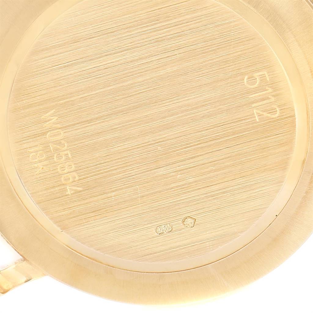The image shows the inside case back of a Rolex Cellini 5112 Men's Yellow Gold Champagne Dial 5112 Men's Yellow Gold Champagne Dial model watch, featuring engraved markings and serial numbers.