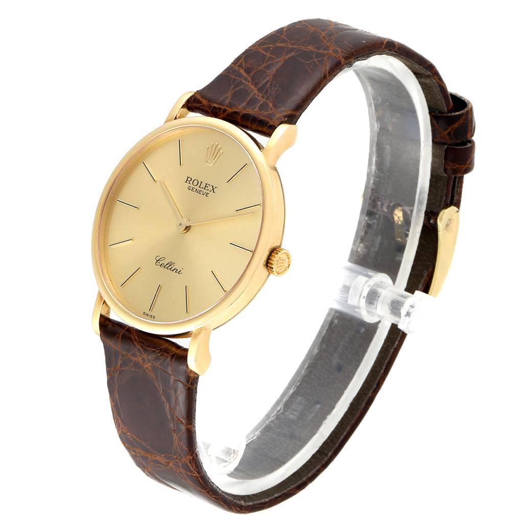 This side-angled shot of the Rolex Cellini 5112 Men's Yellow Gold Champagne Dial 5112 Men's Yellow Gold Champagne Dial watch displays the brown leather strap, gold dial, and gold casing.