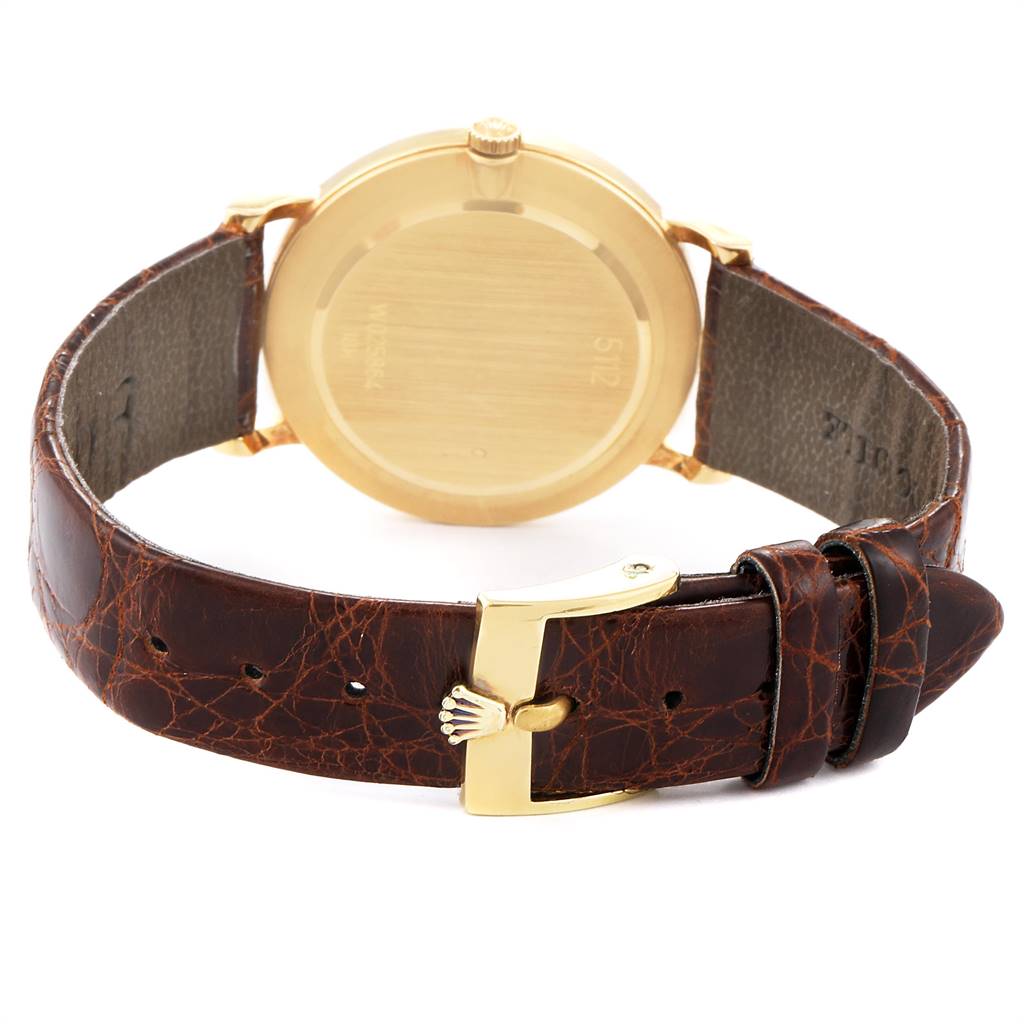 This image shows the back view of the Rolex Cellini 5112 Men's Yellow Gold Champagne Dial 5112 Men's Yellow Gold Champagne Dial watch, highlighting the case back, brown leather strap, and gold buckle.