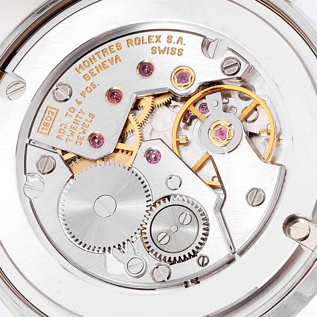 The image shows the intricate inner mechanical movement of a Rolex Cellini 5116 Men's White Gold Grey Dial 5116 Men's White Gold Grey Dial watch, focusing on gears and jewels.
