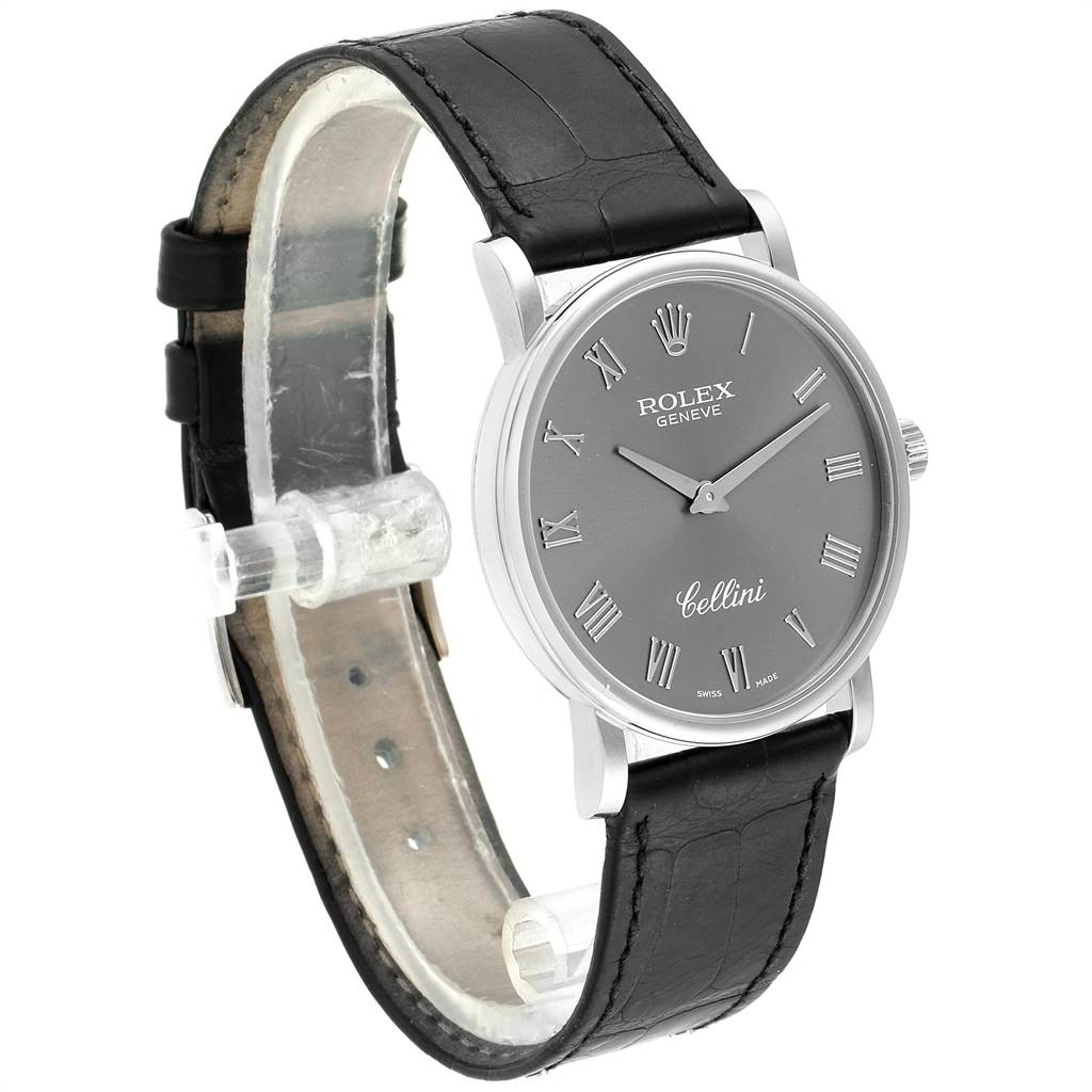 The Rolex Cellini 5115 Men's White Gold Grey Dial 5115 Men's White Gold Grey Dial watch is shown at a left side angle, displaying its black leather strap and gray dial with Roman numerals.