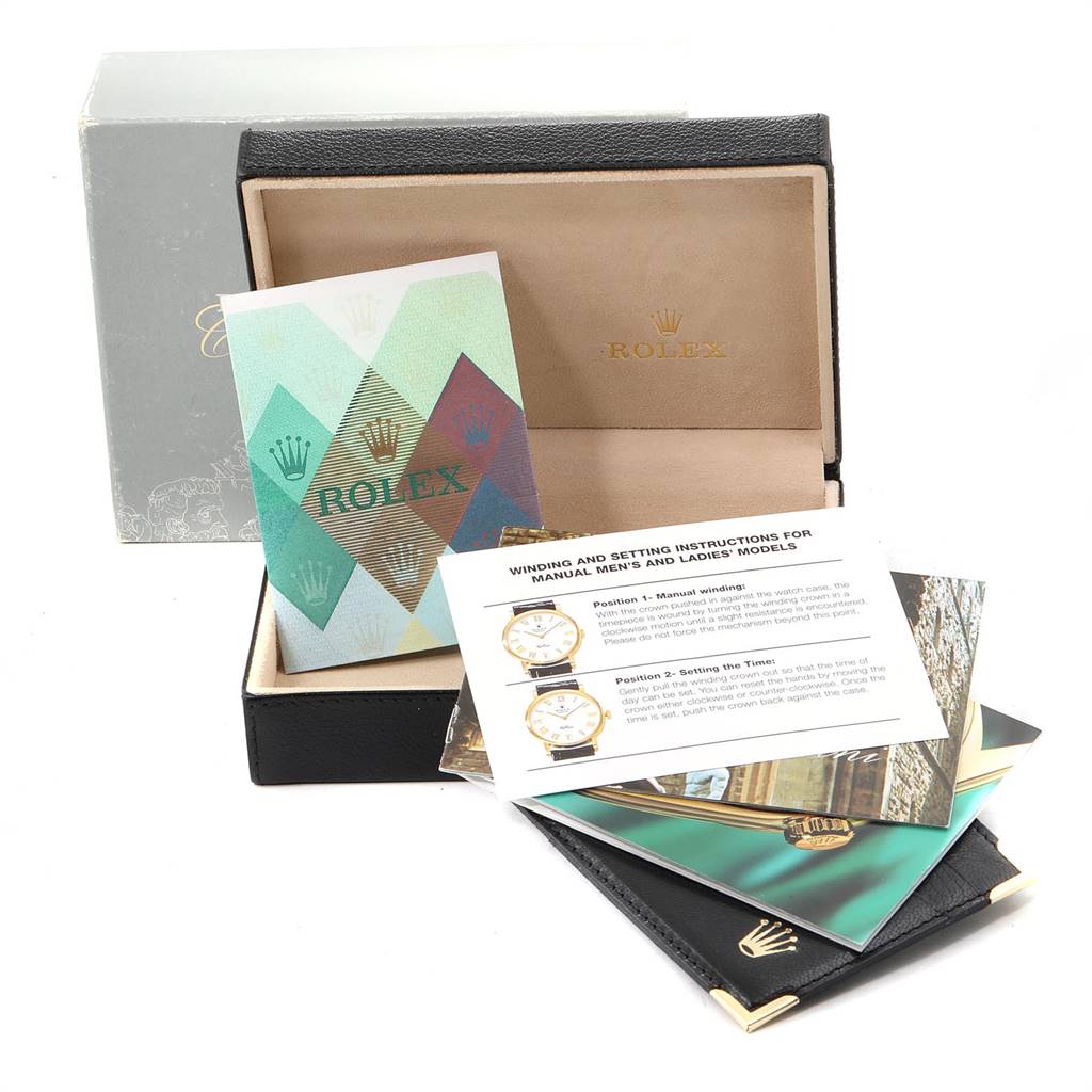 The image shows an open Rolex Cellini 4233 Men
s White Gold Black Dial 4233 Men
s White Gold Black Dial watch box with instruction manuals and pamphlets.