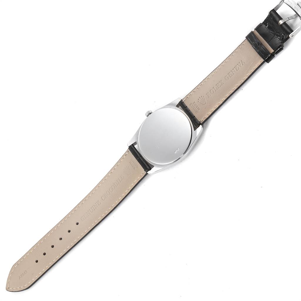 The image shows the back view of a Rolex Cellini 4233 Men
s White Gold Black Dial 4233 Men
s White Gold Black Dial watch, including the case back, crown, and leather strap.