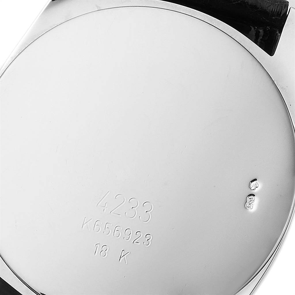 The image shows the case back of a Rolex Cellini 4233 Men
s White Gold Black Dial 4233 Men
s White Gold Black Dial watch, highlighting its engraved model number and 18K gold stamp.