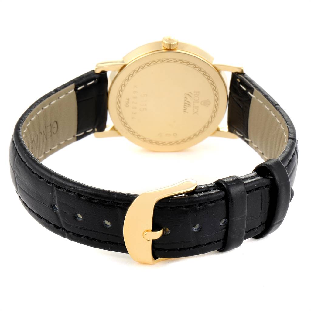The image displays the back of a Rolex Cellini 5115 Men's Yellow Gold Mother of Pearl Dial 5115 Men's Yellow Gold Mother of Pearl Dial watch along with its black leather strap and gold buckle.