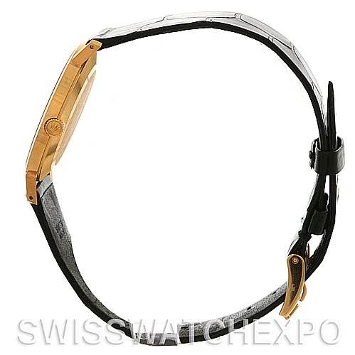 The image shows a Rolex Cellini 4112 Yellow Gold White Dial 4112 Yellow Gold White Dial watch from a side profile, highlighting its gold case, crown, and black leather strap.