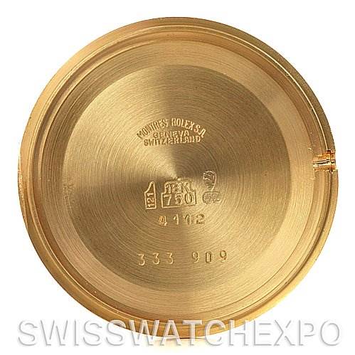 This image shows the inside of the back case of a Rolex Cellini 4112 Yellow Gold White Dial 4112 Yellow Gold White Dial watch, featuring various engravings and hallmarks.