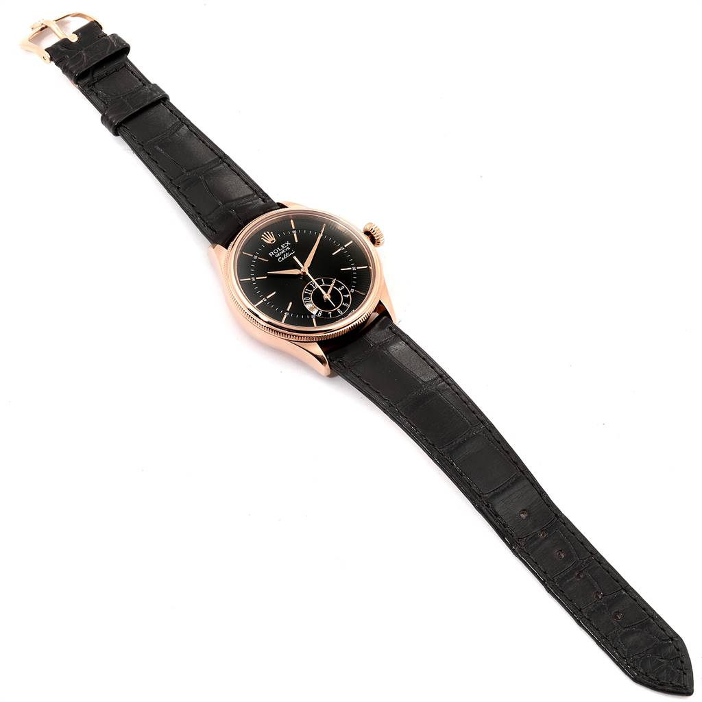The Rolex Cellini 50525 Men
s Rose Gold Black Dial 50525 Men
s Rose Gold Black Dial watch is shown at an angled, top-down view, displaying its black dial, rose gold case, and black leather strap.