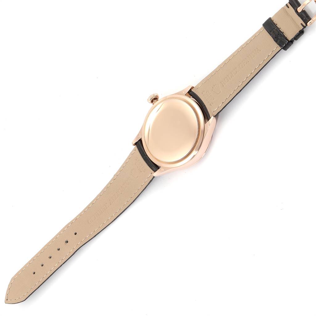 The image shows the back view of a Rolex Cellini 50525 Men
s Rose Gold Black Dial 50525 Men
s Rose Gold Black Dial watch, displaying the case back and leather strap.