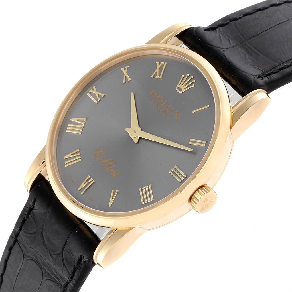 This image shows a Rolex Cellini 5116 Men's Yellow Gold Grey Dial 5116 Men's Yellow Gold Grey Dial watch at an angle that highlights its black leather strap, gray dial, and gold-tone case.