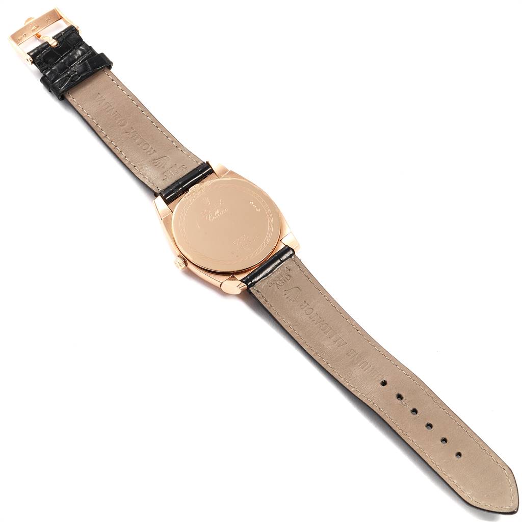 The image shows the back side of a Rolex Cellini 5330 Men's Rose Gold Grey Dial 5330 Men's Rose Gold Grey Dial watch including its case and leather strap laid flat.