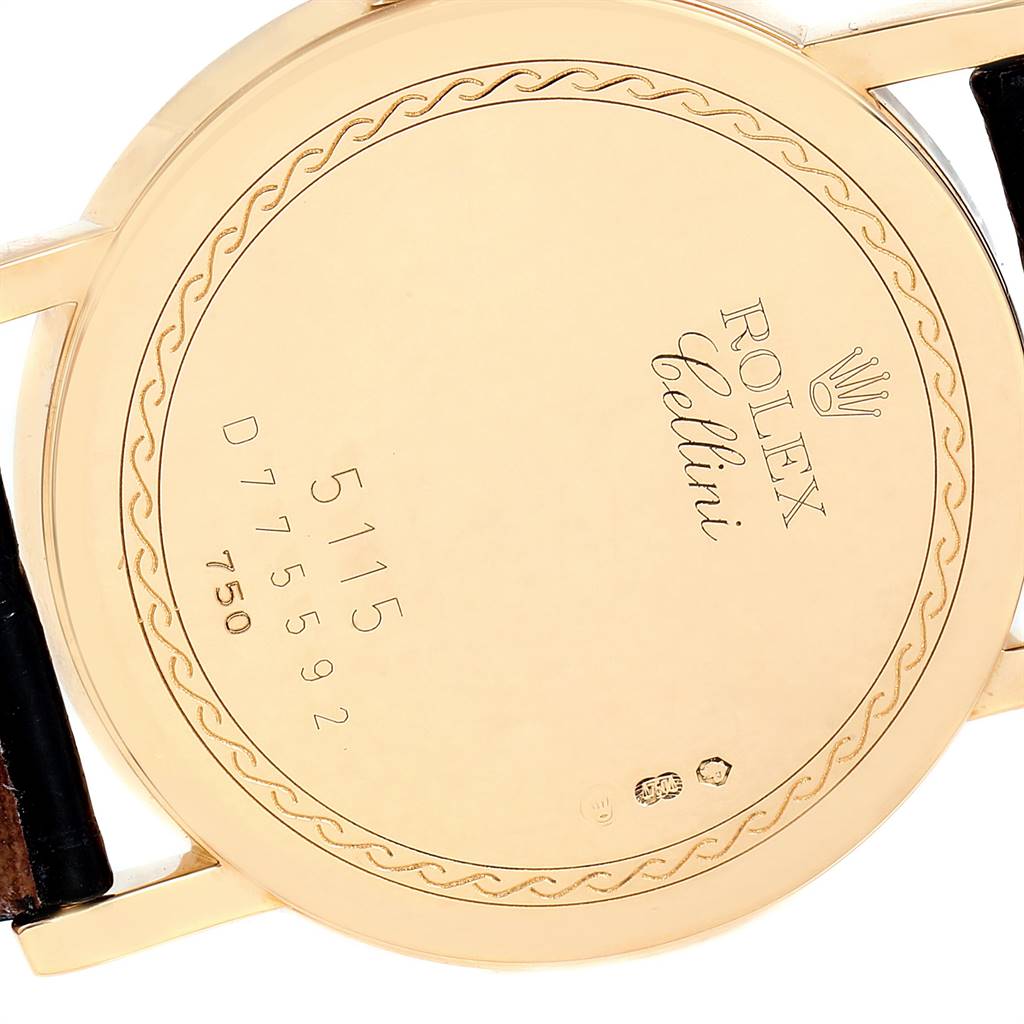 The image shows the back case and part of the strap of a Rolex Cellini 5115 Men's Yellow Gold Beige Dial 5115 Men's Yellow Gold Beige Dial watch, including its engravings and model number.