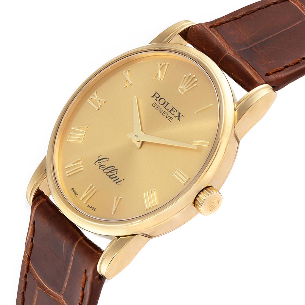 This image shows the face, crown, and part of the leather strap of a Rolex Cellini 5116 Men's Yellow Gold Champagne Dial 5116 Men's Yellow Gold Champagne Dial watch at an angled view.