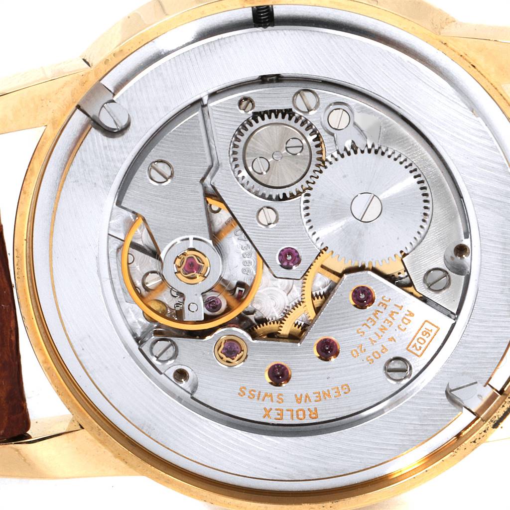 This close-up image of the Rolex Cellini 5116 Men's Yellow Gold Champagne Dial 5116 Men's Yellow Gold Champagne Dial watch shows its intricate movement and internal mechanical parts.