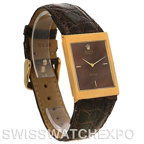 The image shows a Rolex Cellini 4127 Men's Yellow Gold Brown Dial 4127 Men's Yellow Gold Brown Dial watch at a slight angle, featuring its rectangular face, golden bezel, and brown leather strap.