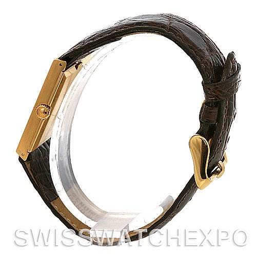 The Rolex Cellini 4127 Men's Yellow Gold Brown Dial 4127 Men's Yellow Gold Brown Dial watch is shown from a side angle, highlighting its gold case, crown, and brown leather strap with buckle.