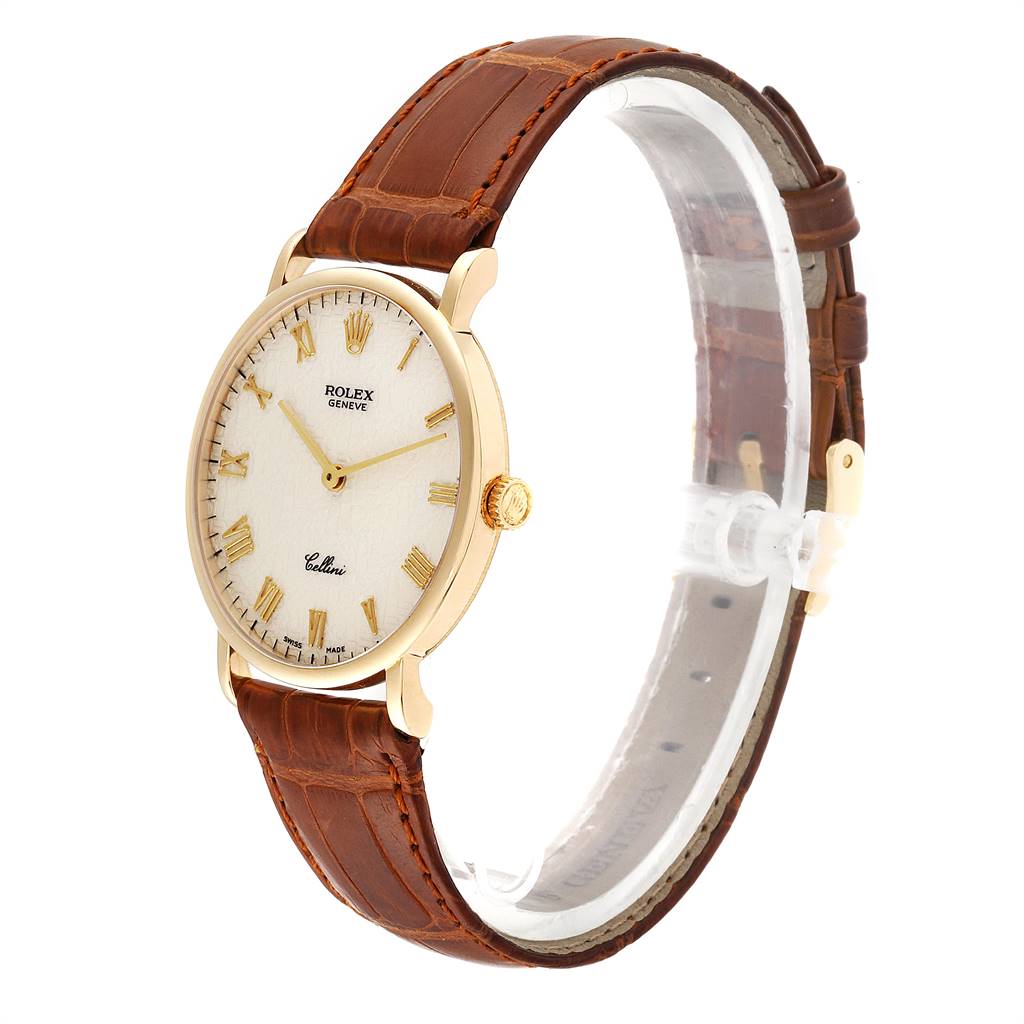 This image shows a Rolex Cellini 5112 Men's Yellow Gold Beige Dial 5112 Men's Yellow Gold Beige Dial watch at a slightly angled side view, with a brown leather strap and gold casing.
