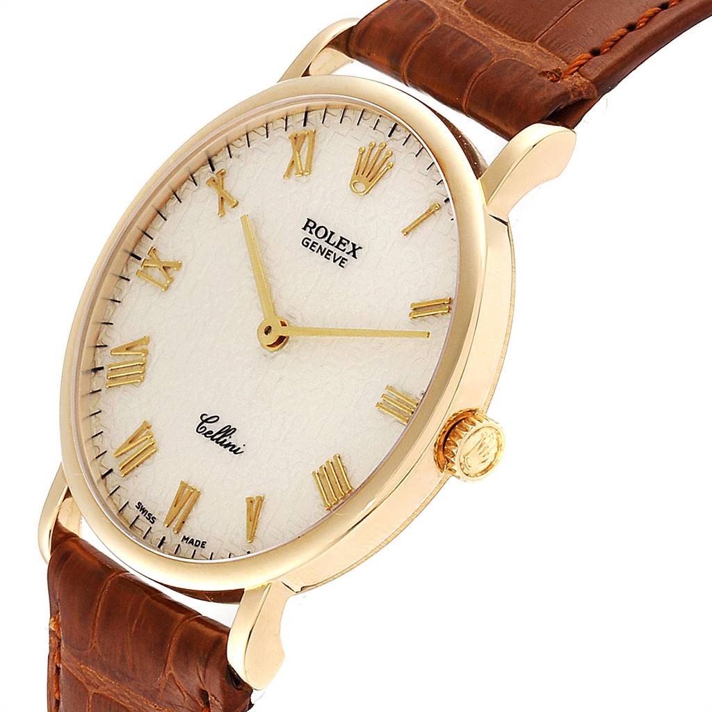 The image shows a side angle of a Rolex Cellini 5112 Men's Yellow Gold Beige Dial 5112 Men's Yellow Gold Beige Dial watch, highlighting its dial, crown, and leather strap.