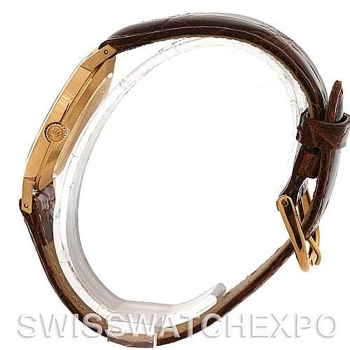 The image shows a side view of a Rolex Cellini 4112 Yellow Gold Grey Dial 4112 Yellow Gold Grey Dial model watch, highlighting the crown, case, and leather strap.