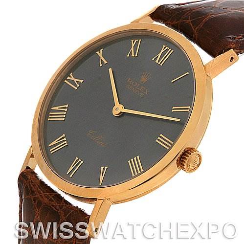 The image shows a side angle of a Rolex Cellini 4112 Yellow Gold Grey Dial 4112 Yellow Gold Grey Dial watch, highlighting its gold case, black dial with Roman numerals, and brown leather strap.