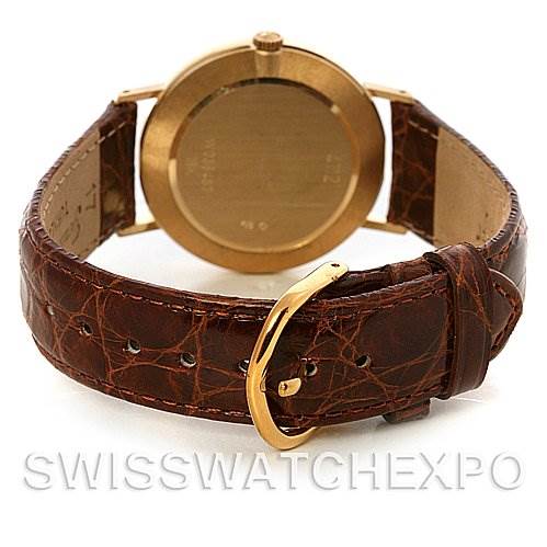 This image shows the back view of a Rolex Cellini 4112 Yellow Gold Grey Dial 4112 Yellow Gold Grey Dial watch, highlighting its gold case and brown leather strap with a gold buckle.