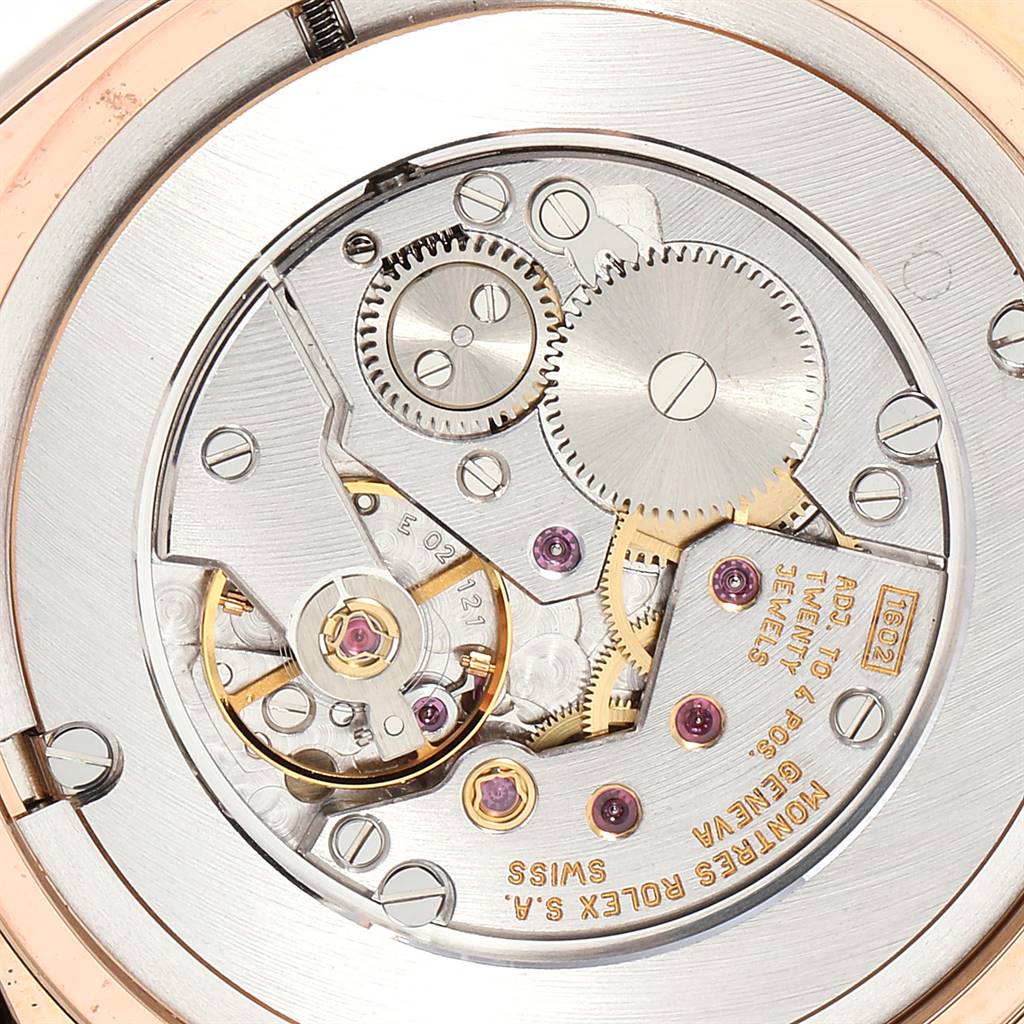 This close-up image shows the intricate internal mechanics of a Rolex Cellini 5330 Men's Rose Gold Grey Dial 5330 Men's Rose Gold Grey Dial watch, including gears and inscriptions on the movement.