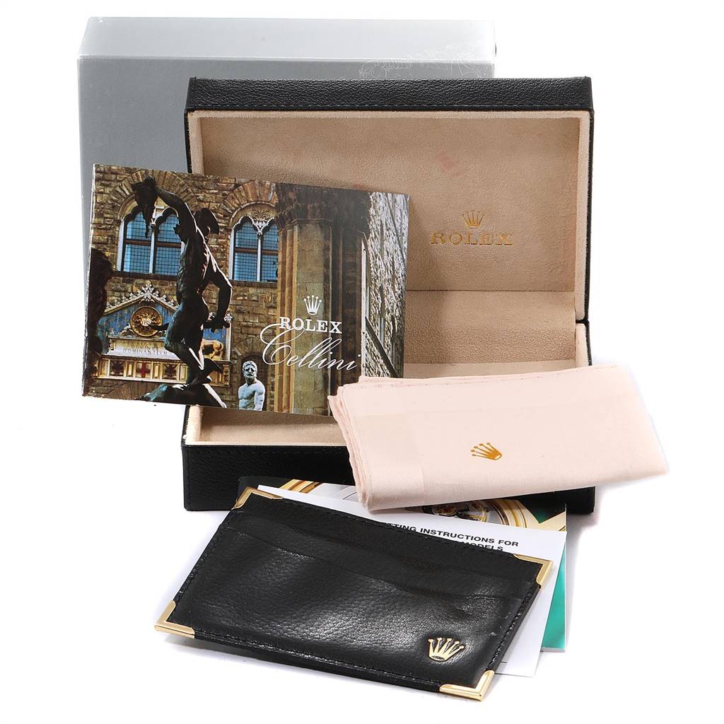 This image shows the box, manual, and leather wallet of a Rolex Cellini 5112 Men's Yellow Gold White Dial 5112 Men's Yellow Gold White Dial watch.