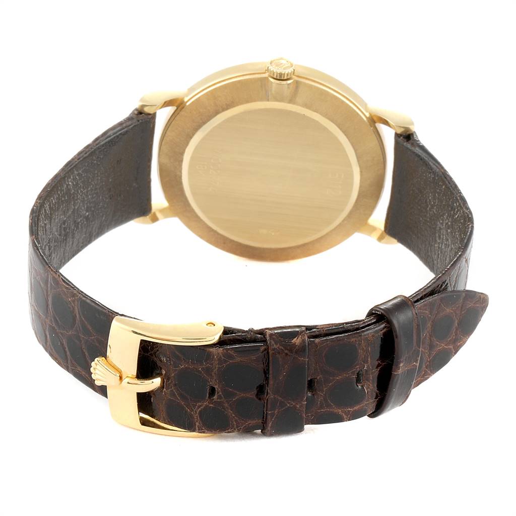 The image shows the rear view of the Rolex Cellini 5112 Men's Yellow Gold White Dial 5112 Men's Yellow Gold White Dial watch, highlighting its back casing and leather strap with a gold buckle.