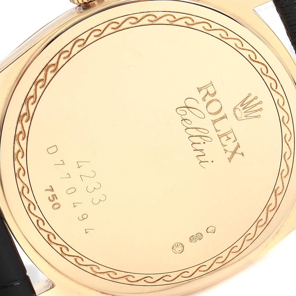 The image shows a close-up of the back case of a Rolex Cellini 4233 Men's Yellow Gold Black Dial 4233 Men's Yellow Gold Black Dial watch, displaying its engraved details and serial number.