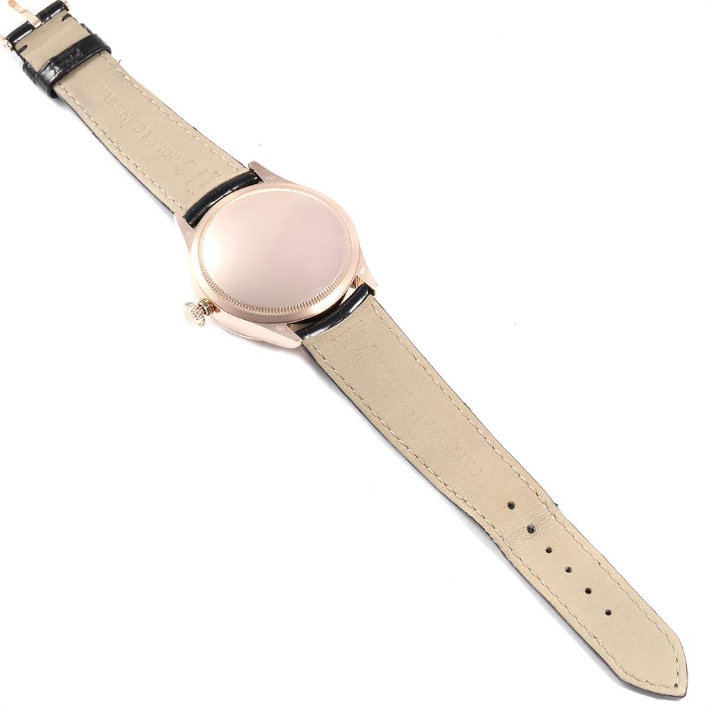 The image shows the back view of a Rolex Cellini 50515 Men's Rose Gold Silver Dial 50515 Men's Rose Gold Silver Dial watch with its beige leather strap fully extended.