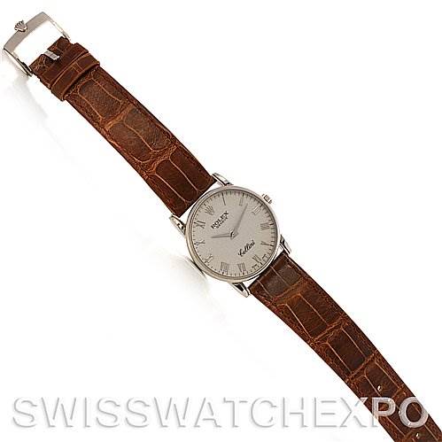 The image shows a top view of a Rolex Cellini 5116/9 White Gold Beige Dial 5116/9 White Gold Beige Dial model watch with a brown leather strap and a silver dial.