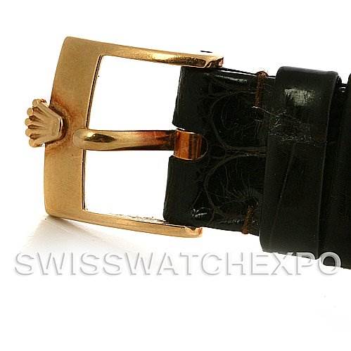 The image shows the buckle of a Rolex Cellini 4112 Yellow Gold White Dial 4112 Yellow Gold White Dial watch, highlighting its gold-tone clasp and black leather strap.