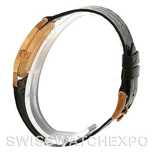 The image shows a side view of the Rolex Cellini 4112 Yellow Gold Champagne Dial 4112 Yellow Gold Champagne Dial watch, highlighting the black strap and gold case.