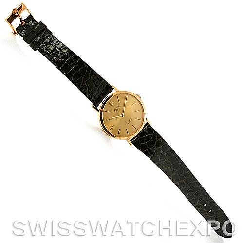 The image shows a top-down view of a Rolex Cellini 4112 Yellow Gold Champagne Dial 4112 Yellow Gold Champagne Dial watch with a gold case and black leather strap.