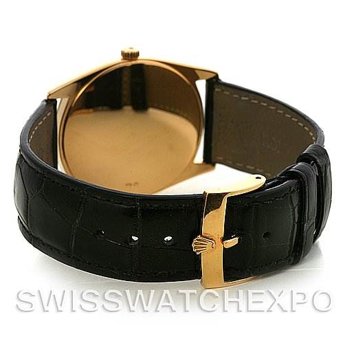 The image shows the back and clasp of a Rolex Cellini 4233 Yellow Gold White Dial 4233 Yellow Gold White Dial watch, highlighting its leather strap and gold-tone buckle.