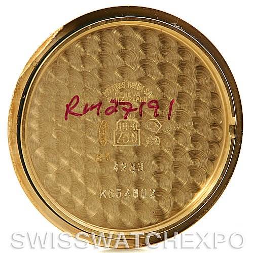 This is the inner case back of a Rolex Cellini 4233 Yellow Gold White Dial 4233 Yellow Gold White Dial model, showing engravings with model and serial numbers.